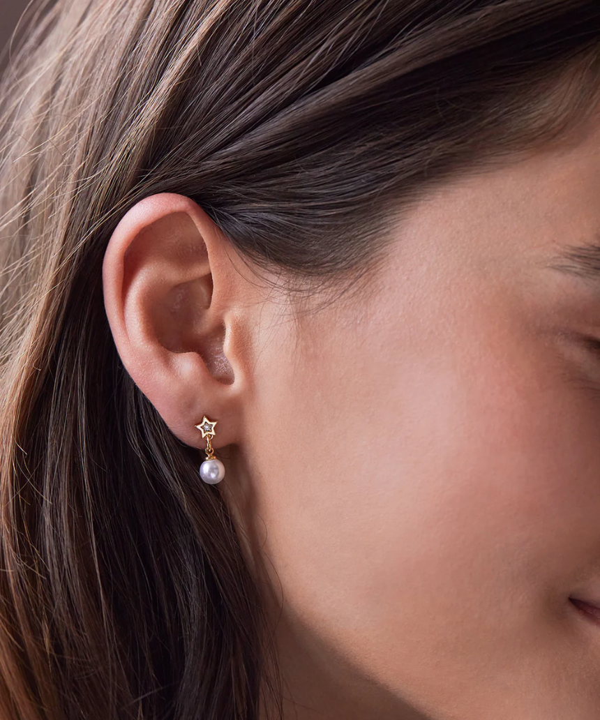 Estella Bartlett star and pearl stud earrings featuring small pearl accents and star-shaped designs on silver posts.