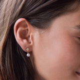 Estella Bartlett star and pearl stud earrings featuring small pearl accents and star-shaped designs on silver posts.