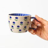 Jones & Co Chino Mug with Forget Me Knot design, featuring a stylish ceramic mug with elegant pattern and comfortable handle.
