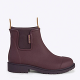 Dark cherry Merry People Bobbi gumboots on a white background, showcasing waterproof rubber footwear with textured soles.