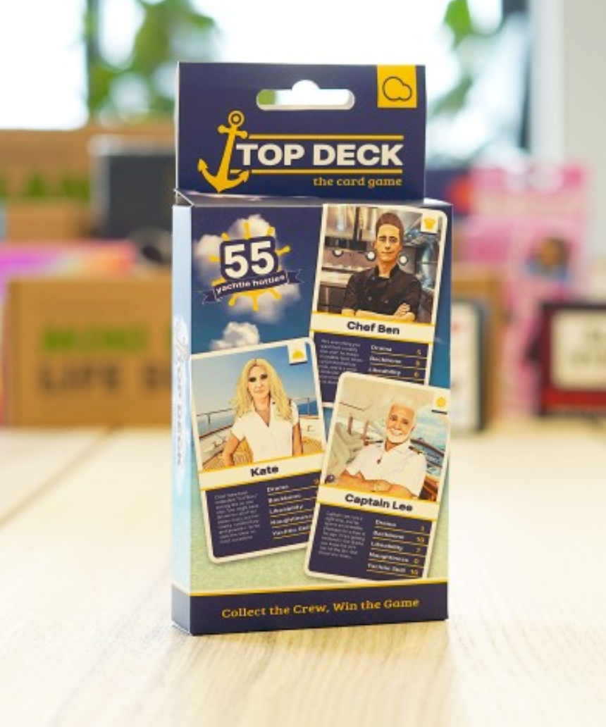 William Valentine Top Deck Card Game with colorful illustrated cards laid out on a table.