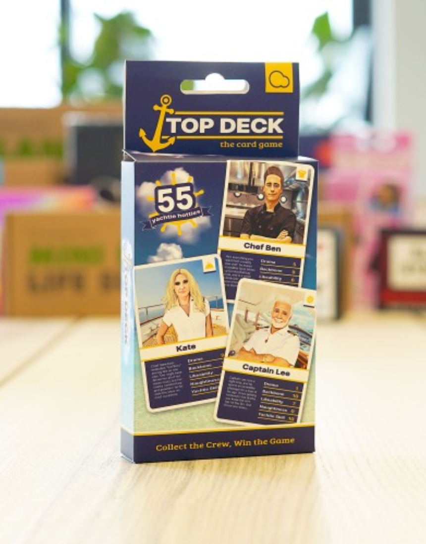 William Valentine Top Deck Card Game with colorful illustrated cards laid out on a table.