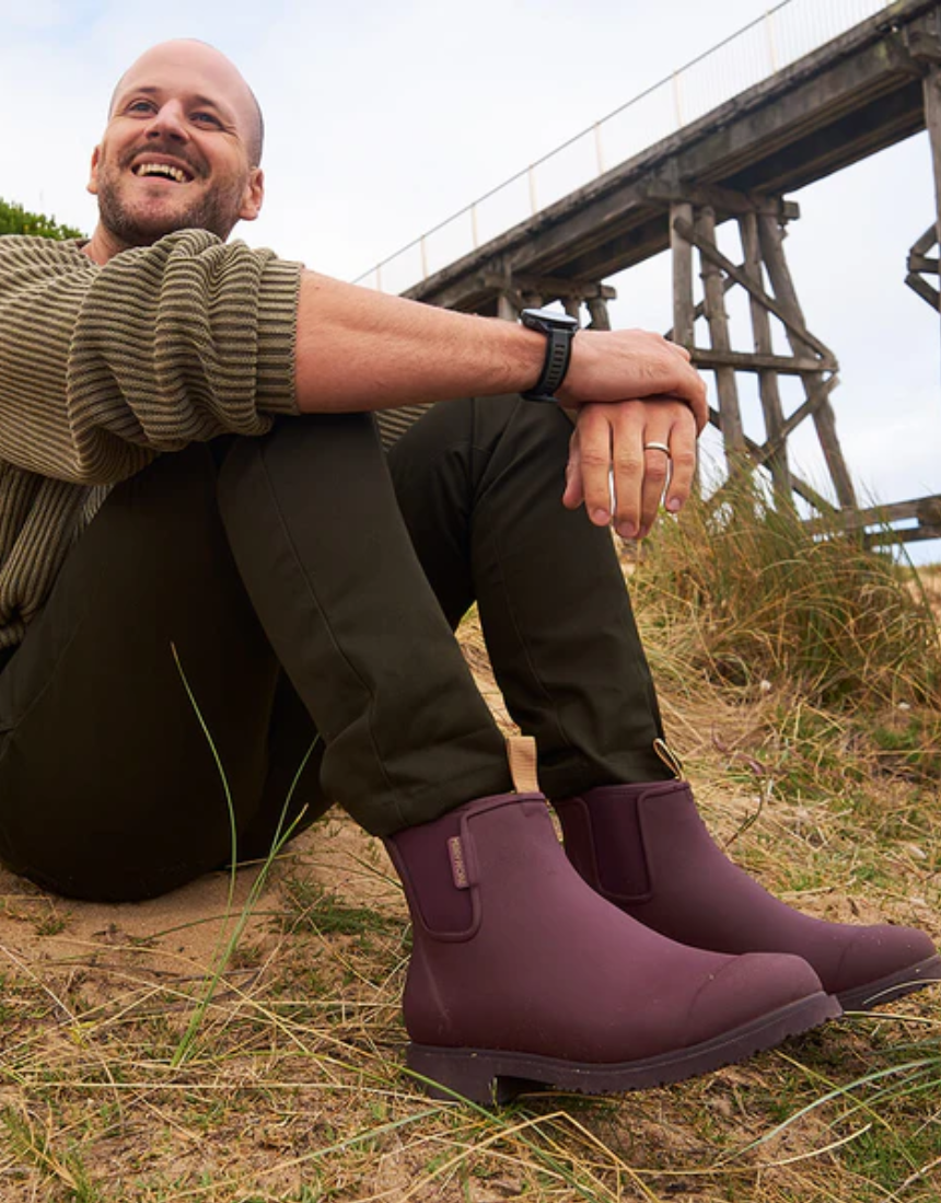 Dark cherry Merry People Bobbi gumboots with a glossy finish and sturdy soles, designed for waterproof outdoor wear.