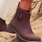Dark cherry Merry People Bobbi gumboots with black soles and shiny finish, stylish waterproof footwear for rainy days.