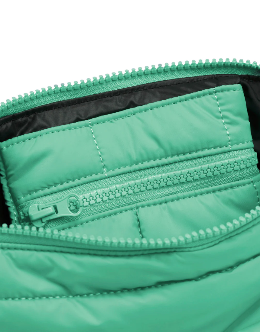 Mint green Cloud Stash Base crossbody bag with adjustable strap and minimalist design, featuring the Base logo and secure zipper closure.
