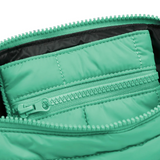 Mint green Cloud Stash Base crossbody bag with adjustable strap and minimalist design, featuring the Base logo and secure zipper closure.