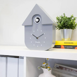 Fisura grey and black cuckoo clock house with dial, intricate wooden design and traditional clock features.
