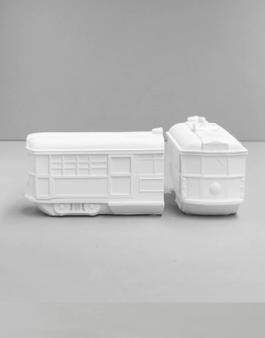 White Moose Tram bookends in white with modern tram design, holding books on a shelf.