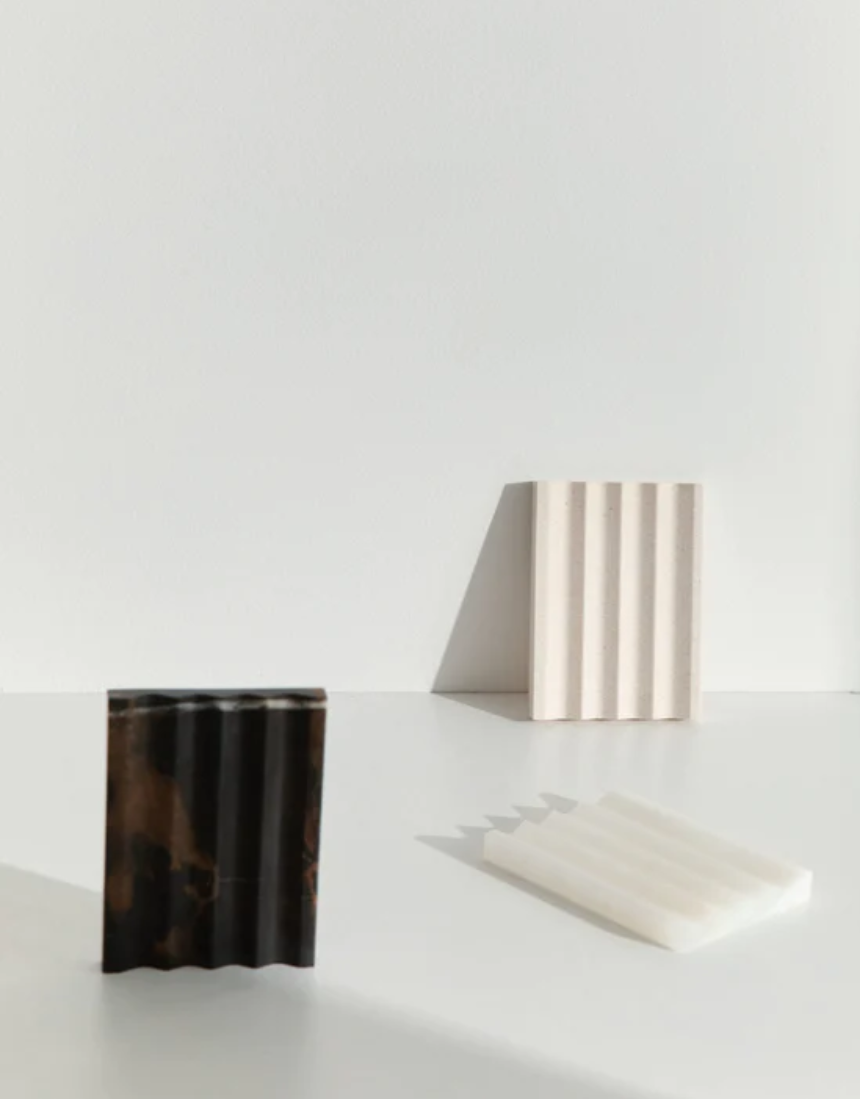 Black marble addition studio stone holder with a sleek, minimalist design for stylish home or office decor.