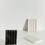 Black marble addition studio stone holder with a sleek, minimalist design for stylish home or office decor.
