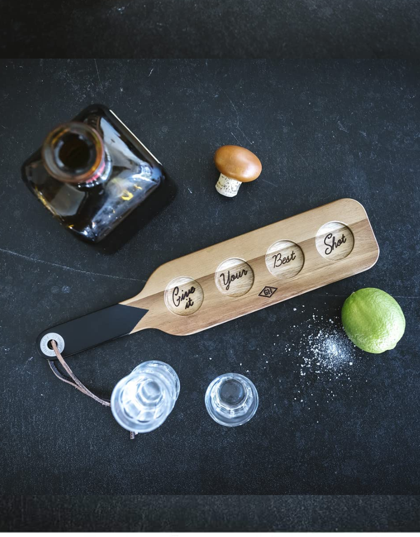 Gentlemen's Hardware shot glasses with a serving paddle, featuring rugged design and clear glass construction.