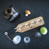 Gentlemen's Hardware shot glasses with a serving paddle, featuring rugged design and clear glass construction.