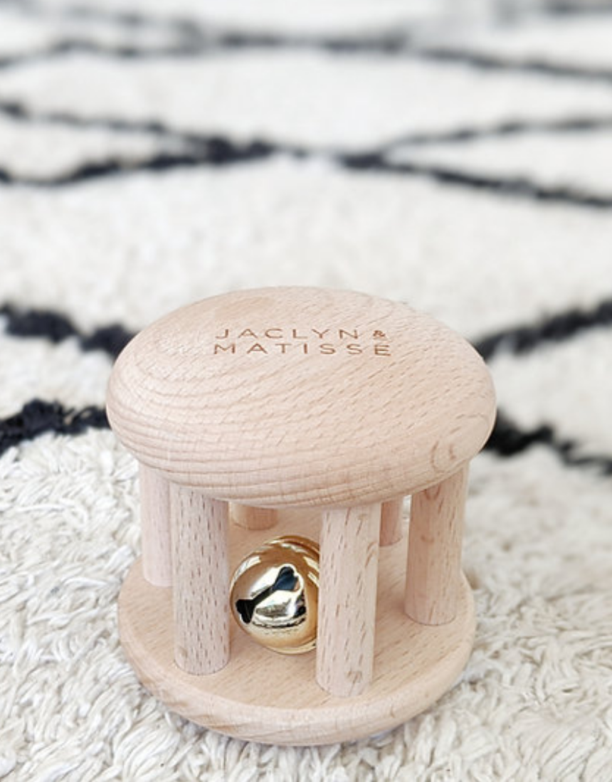 Wooden rattle toy called Bella the Bell from Jaclyn and Matisse, designed for infants and children to shake and play.