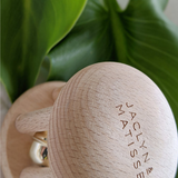 Wooden rattle toy named Bella the Bell by Jaclyn and Matisse, designed for infants with colorful, child-friendly features.