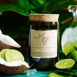 Scented candle from Mojo Candle Co. in coconut and lime fragrance with a sleek glass jar and label design.