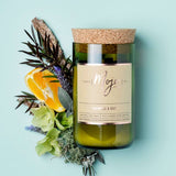 Mojo Candle Co. Oakmoss & Sage candle with a glass jar and natural wax, showcasing a calming scent and elegant design.