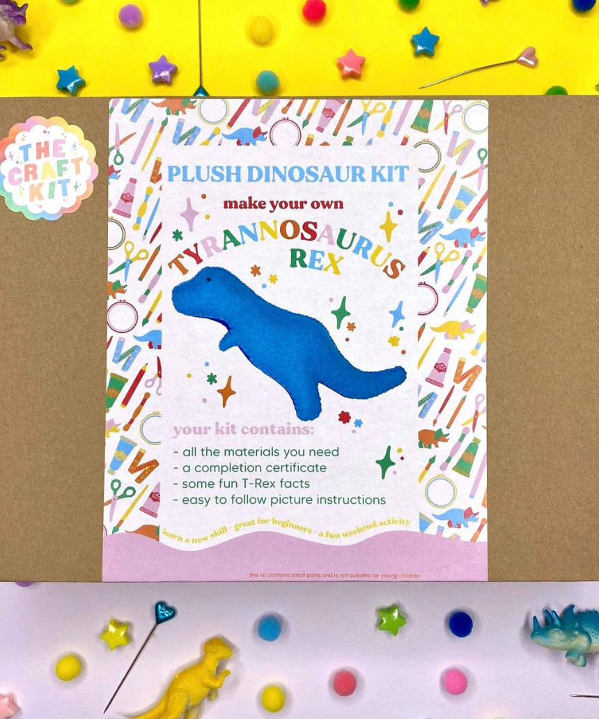 T-Rex felt plush from The Craft Kit needlecraft kit, featuring colorful felt pieces and assembling instructions for a fun craft project.