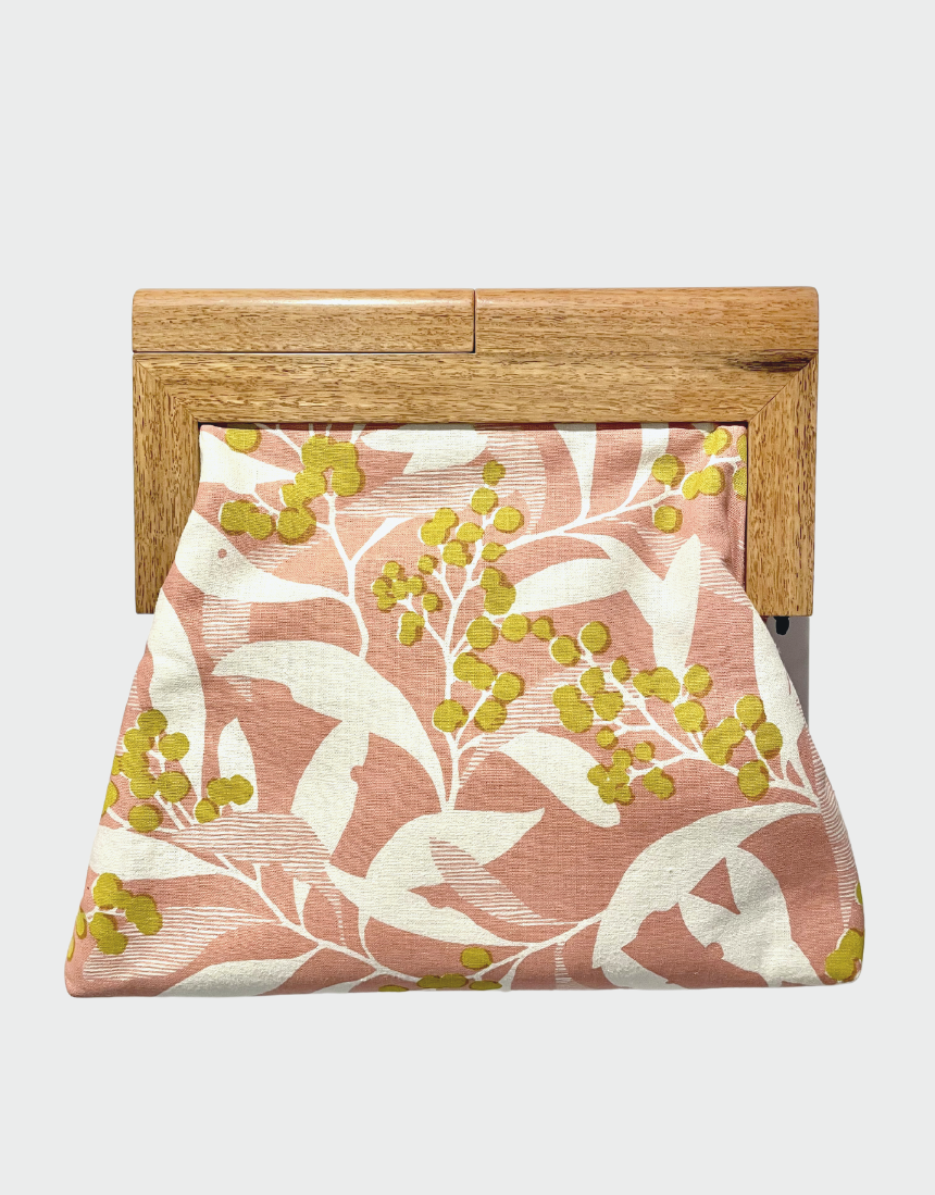 Yellow Bird Signature Medium Clutch with Wattle Tassie Oak frame, showcasing a sleek yellow clutch bag with natural wood accents.
